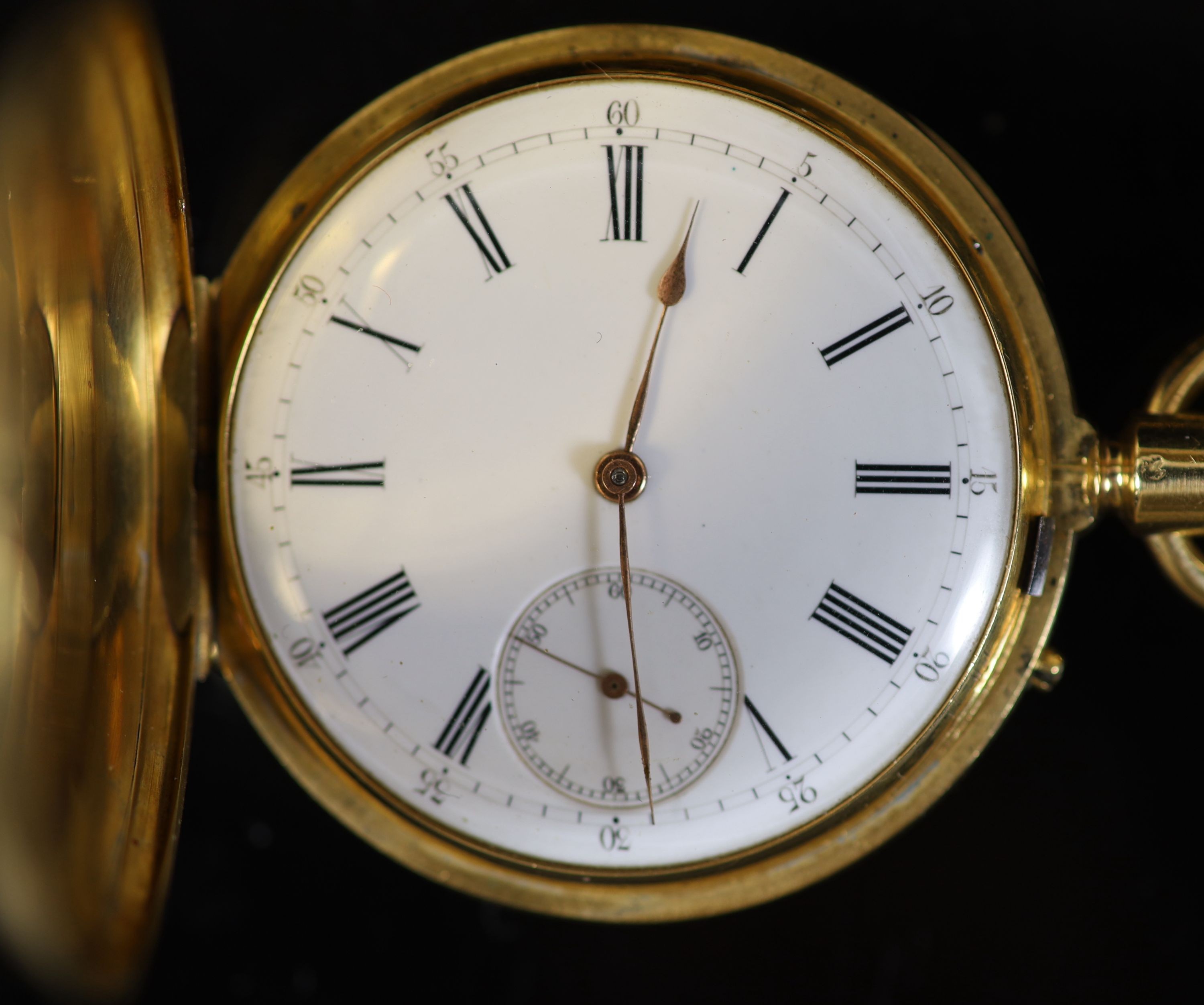 An 18ct gold full hunter keyless lever pocket watch, having white enamel Roman dial with subsidiary seconds dial, engraved monogram, on a 9ct mounted black silk ribbon, with 9ct and amber swivelling fob